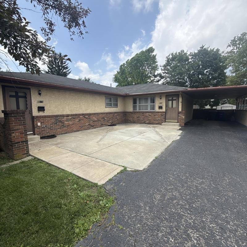 Asphalt shingle roof and carport at duplex property Asphalt shingle roof and carport at duplex property