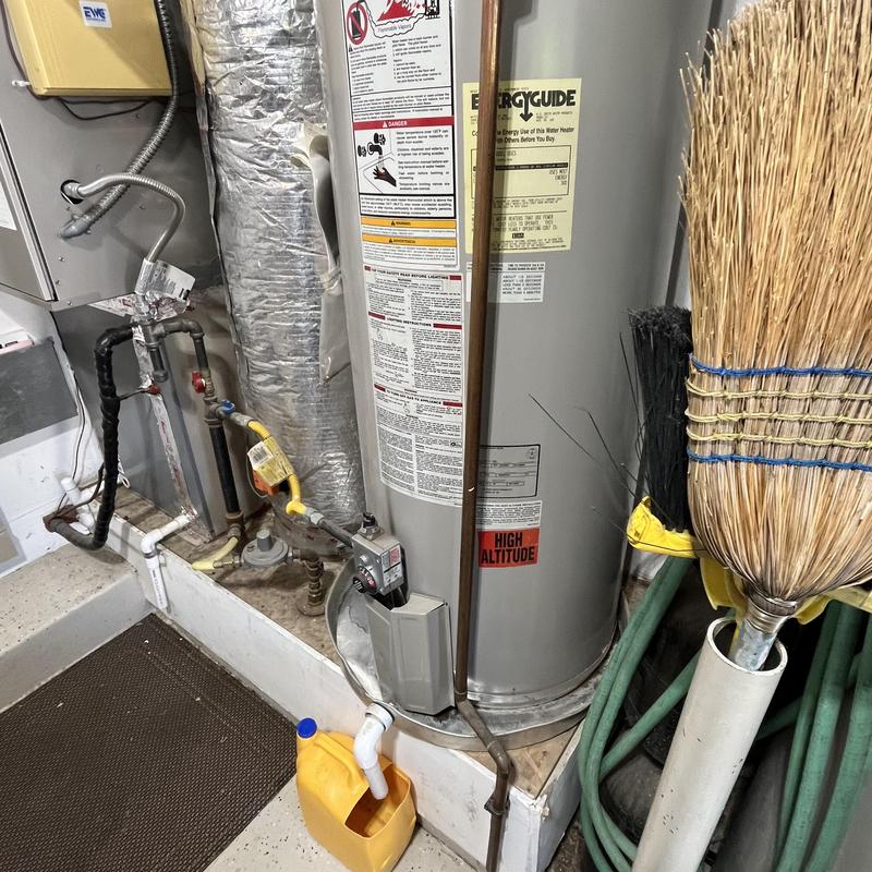 Gas water heater with attached pipes and fittings