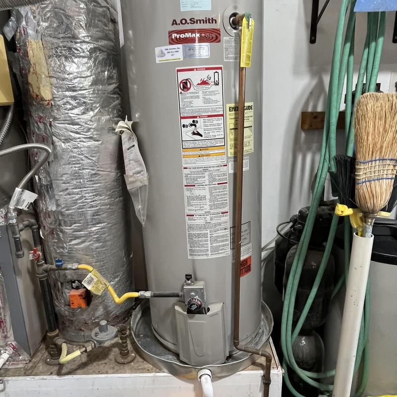 65 gallon gas water heater with gas line and vent pipe