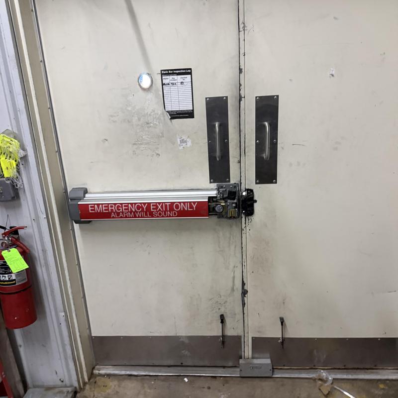 Exit alarm lock on delivery door with panic bar Exit alarm lock on delivery door with panic bar
