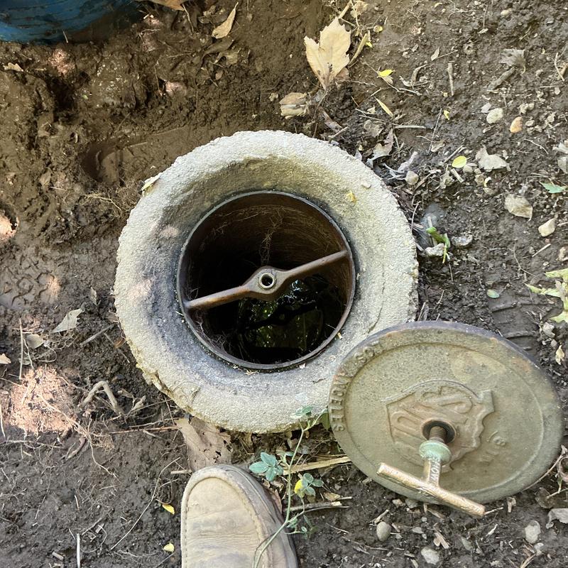 Irrigation valve box with open lid and blockage inspection Irrigation valve box with open lid and blockage inspection