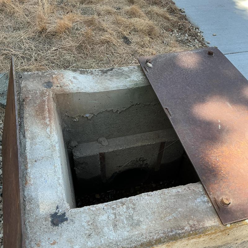 Irrigation valve box with open metal cover Irrigation valve box with open metal cover