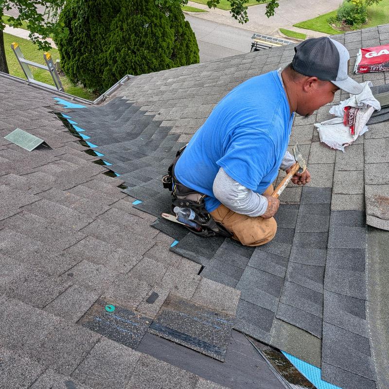 Asphalt roof shingles installation along valley Asphalt roof shingles installation along valley