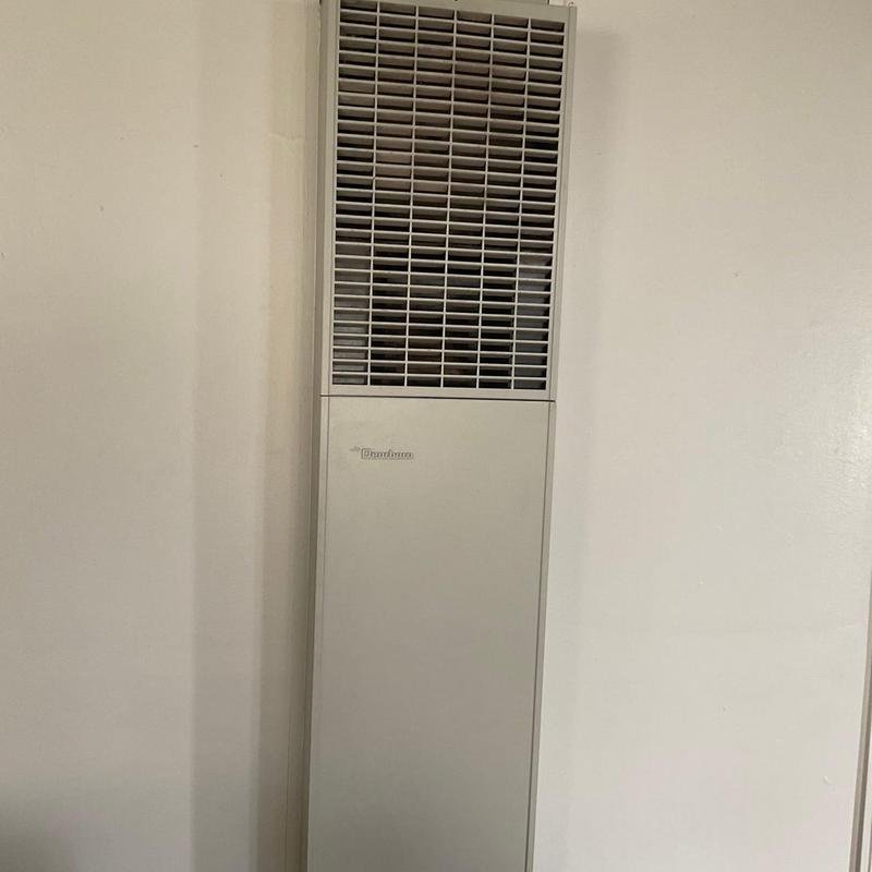 Wall-mounted heater unit with grille and thermostat