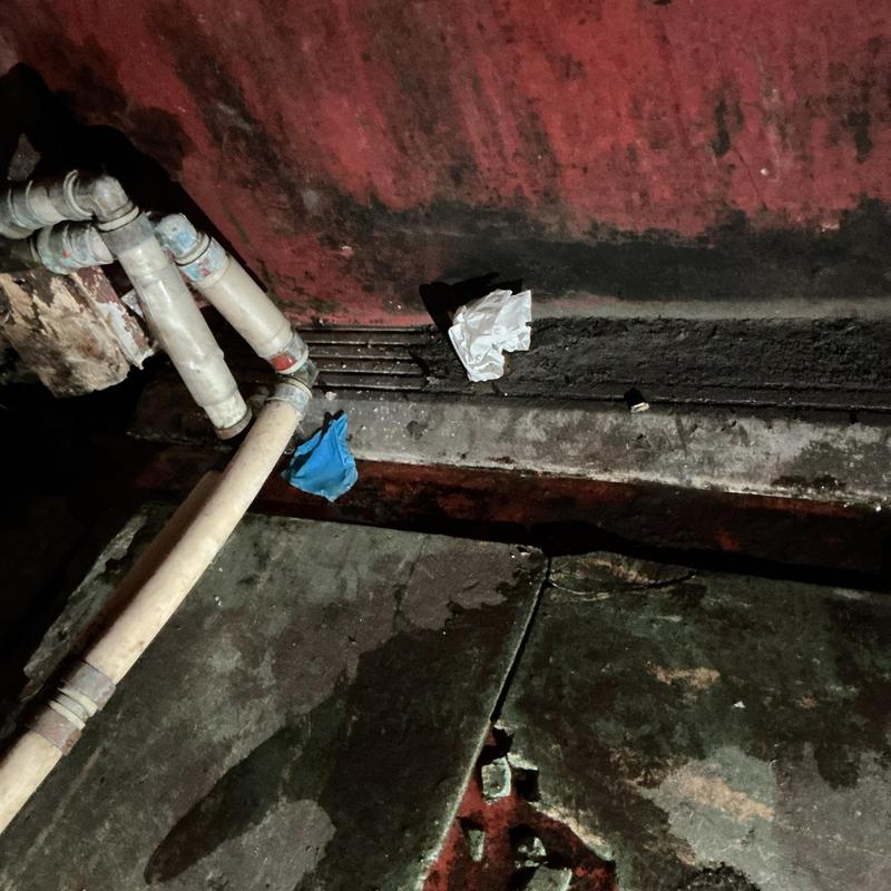 PVC water line with leaking joint near floor wall PVC water line with leaking joint near floor wall