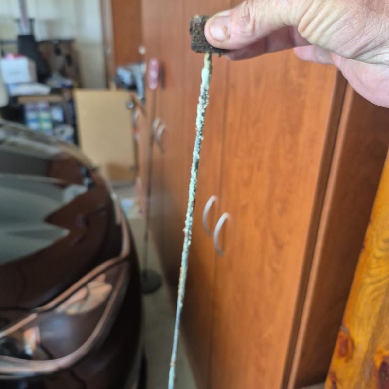 Gas water heater anode rod removed showing corrosion
