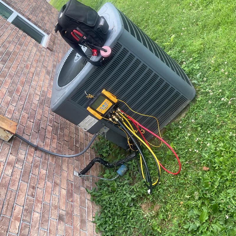 Central air conditioner with diagnostic gauges attached outdoors