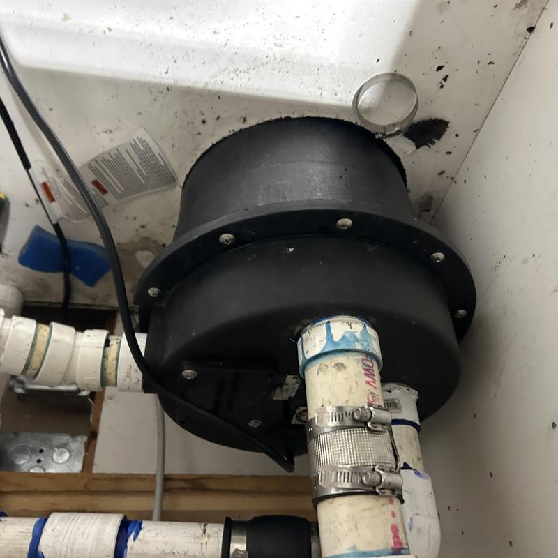 Sewage ejector pump with check valve and pipe clamps