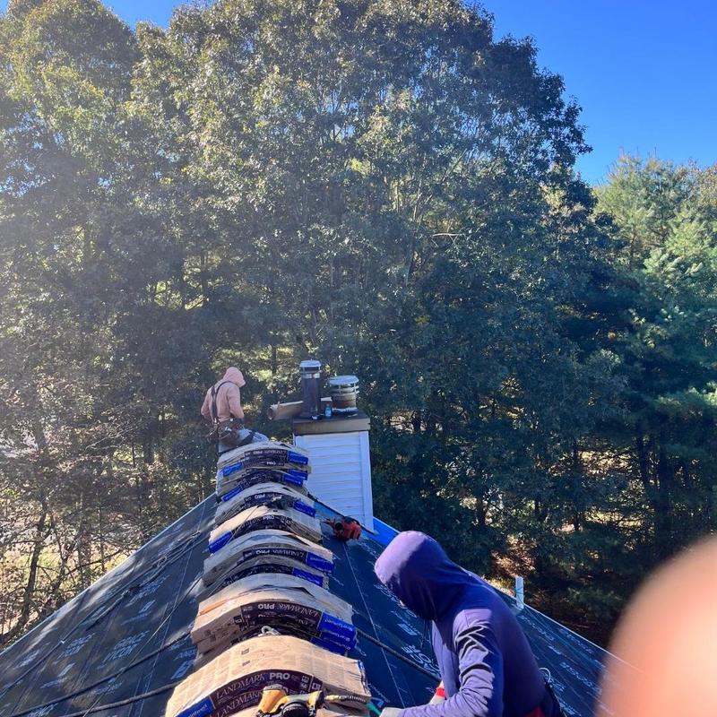 New roof installation with chimney near trees New roof installation with chimney near trees