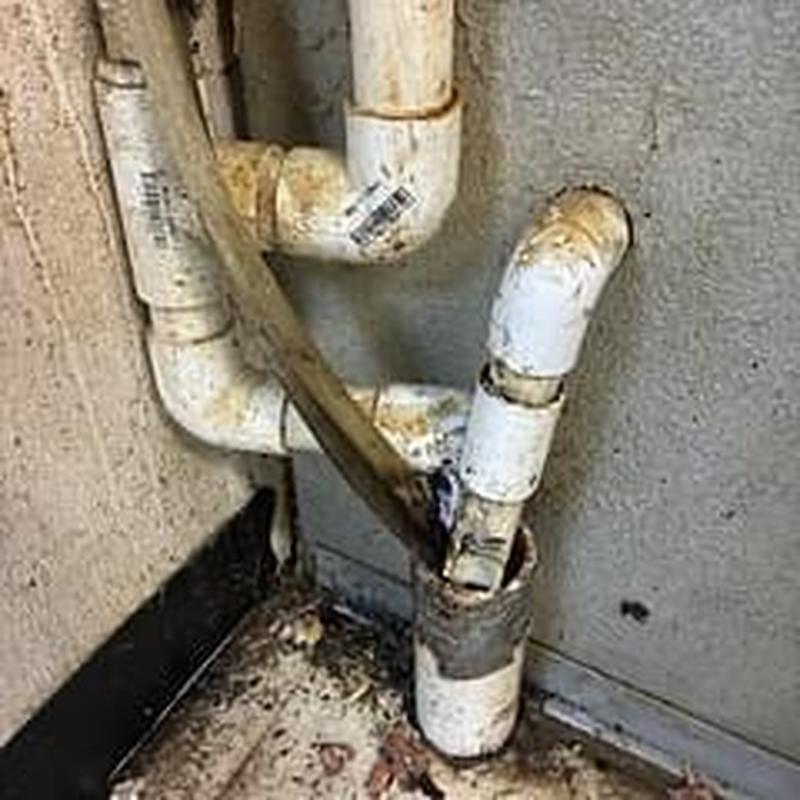 Walk-in cooler drain pipes with rust and debris Walk-in cooler drain pipes with rust and debris