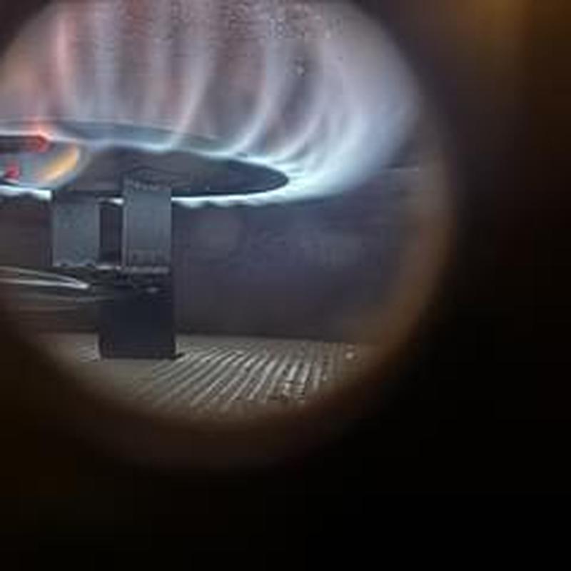 Gas water heater pilot light with blue flame burning Gas water heater pilot light with blue flame burning