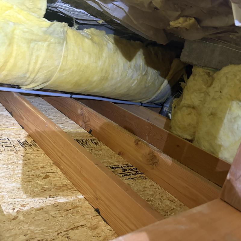 Poly piping under home with insulation in crawl space