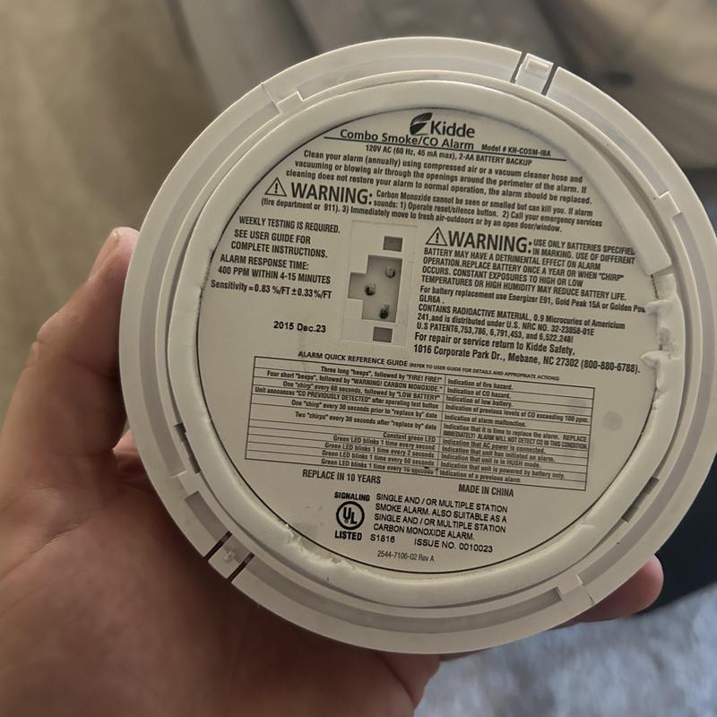 Smoke and CO alarm back view with warning labels
