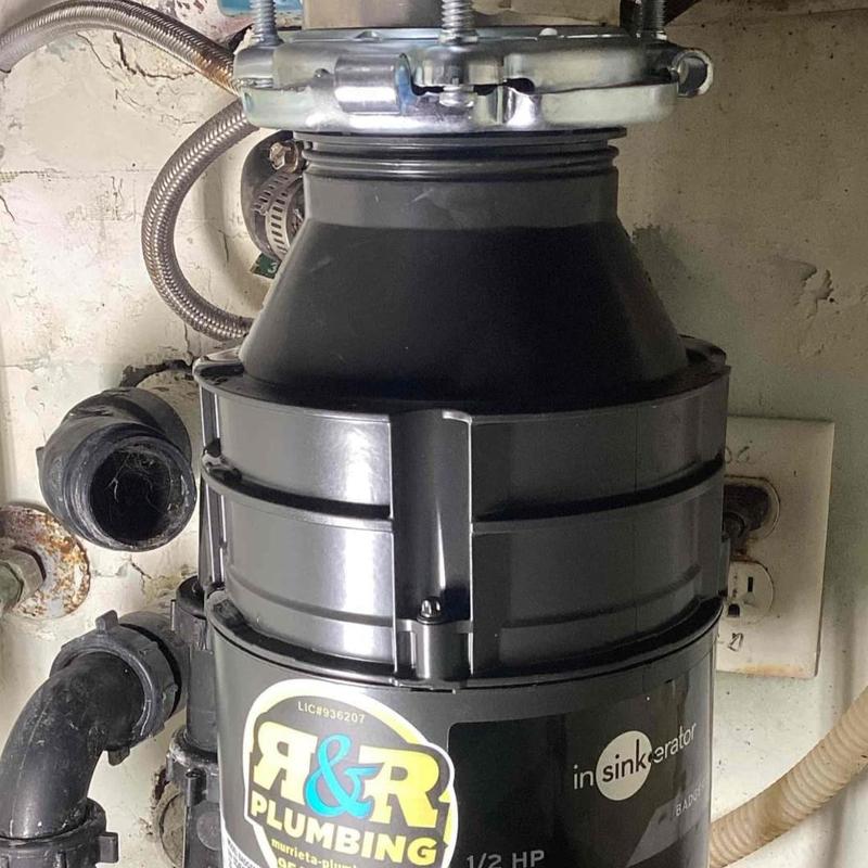 Garbage disposal unit installed under kitchen sink Garbage disposal unit installed under kitchen sink