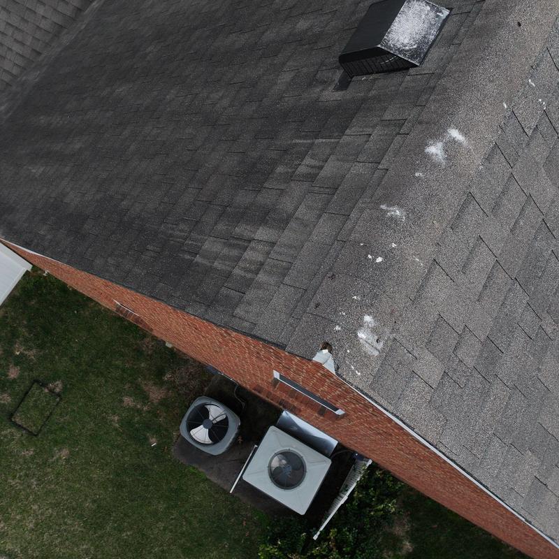 Asphalt shingle roof with hail damage and vent system
