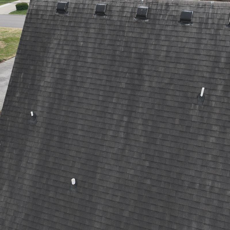 Asphalt shingle roof with hail damage and ventilation vents