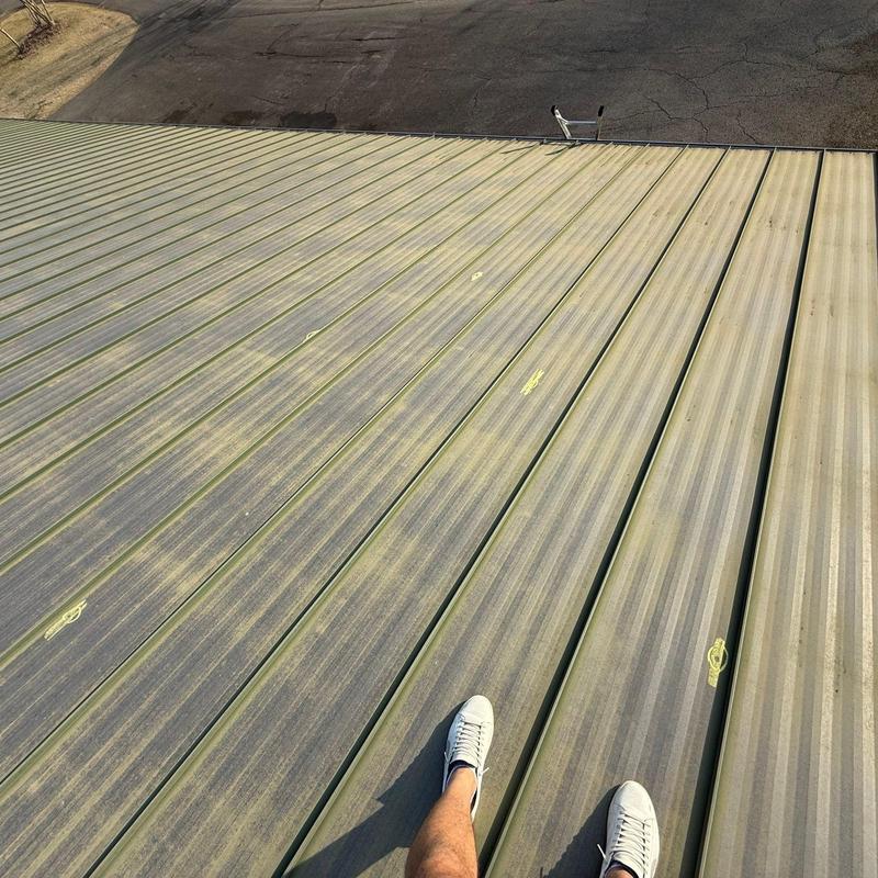Metal roofing panels with hail damage markings