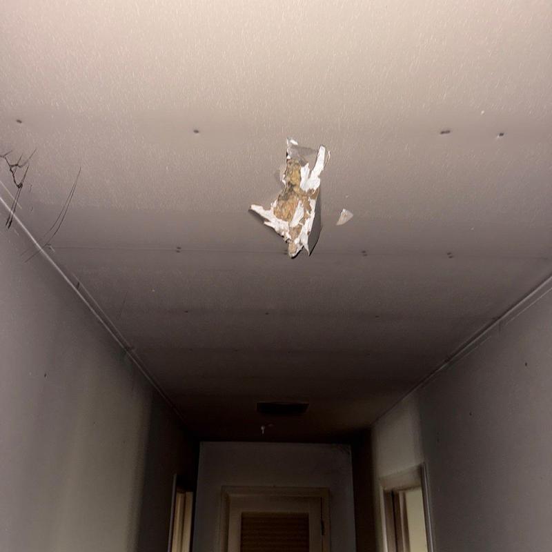 Drywall ceiling with significant water damage hole