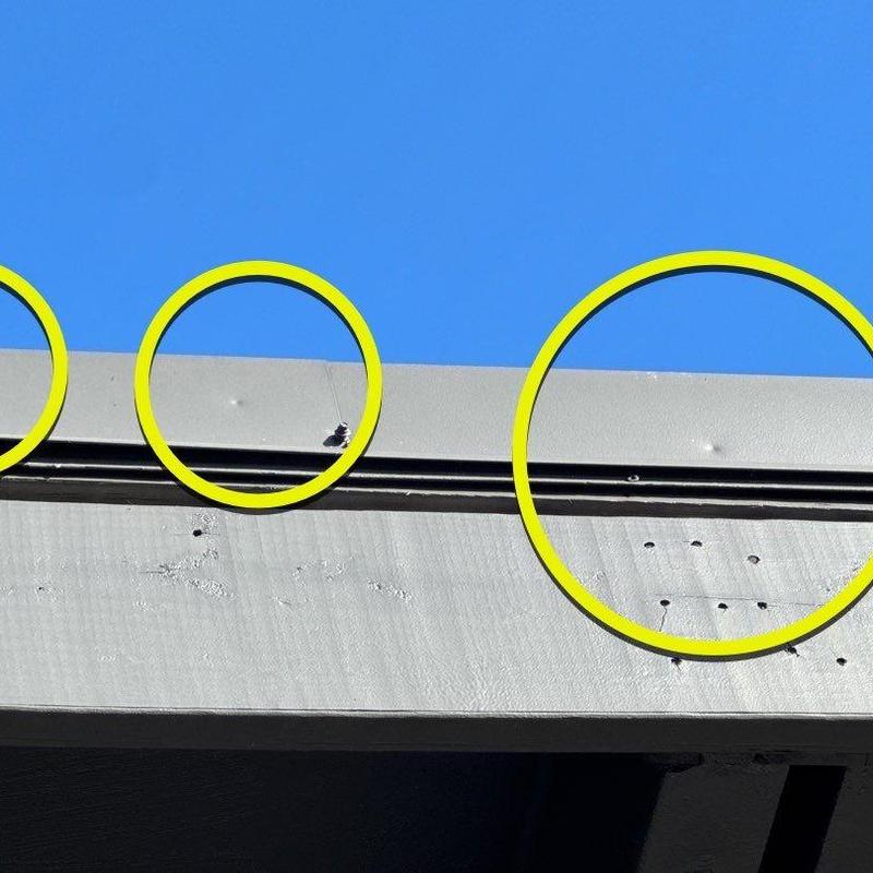 Metal roofing hail damage marked with yellow circles