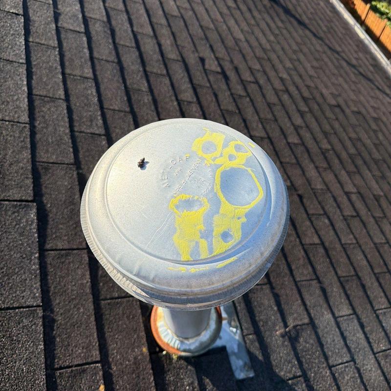 Roof vent cap with hail damage marked in yellow