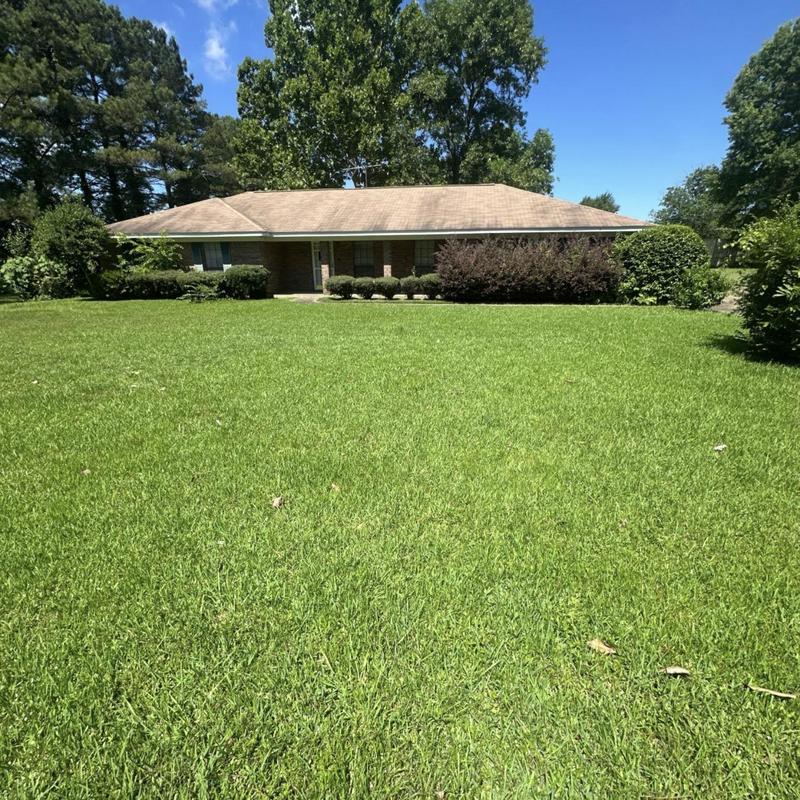 Asphalt shingle roof on residential house with lawn