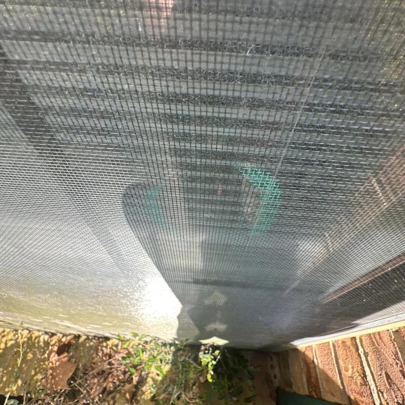 Window screen mesh with exterior shadow and ground view