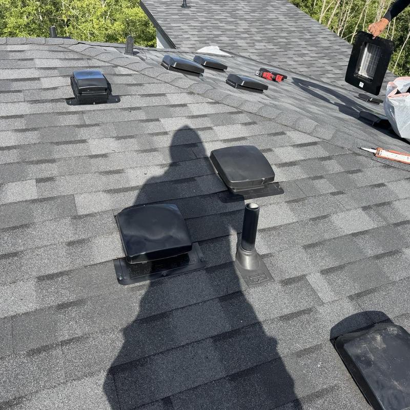 Flapper vents and pipe boots on asphalt roof