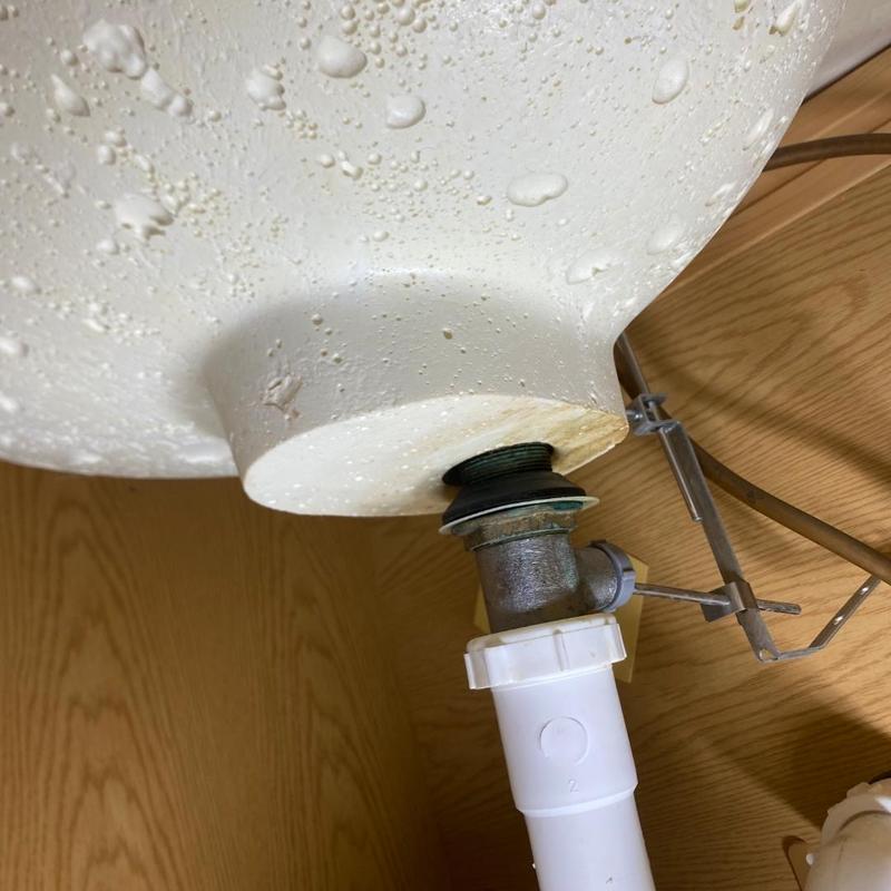 Basket strainer and drain pipe under kitchen sink