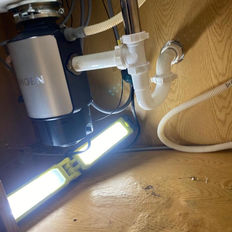 Garbage disposal plumbing and drain pipes under sink