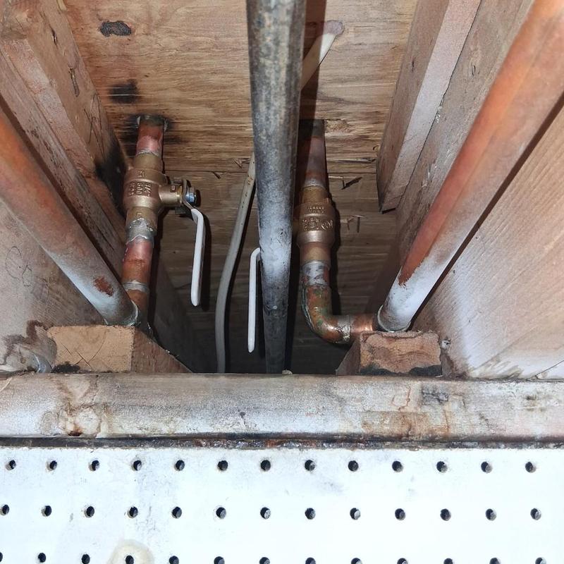Copper gate valves with lever handles in ceiling pipes
