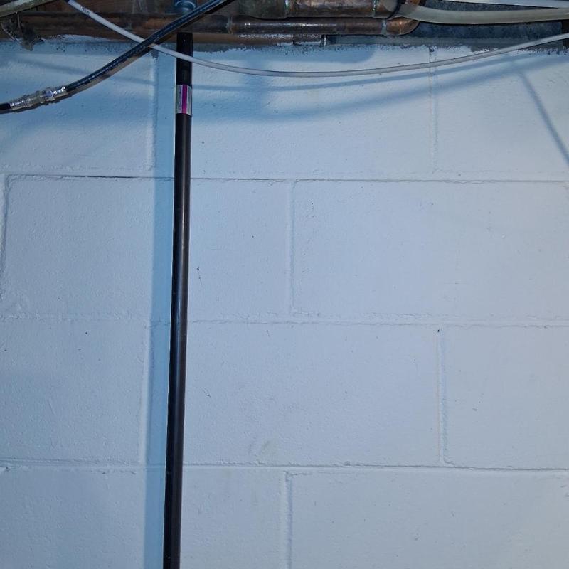 New black gas line pipe installed in basement wall