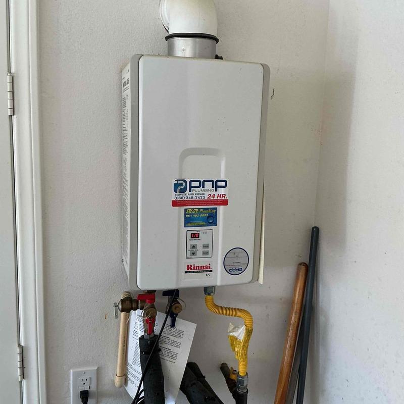 Tankless water heater with flush setup in utility room Tankless water heater with flush setup in utility room