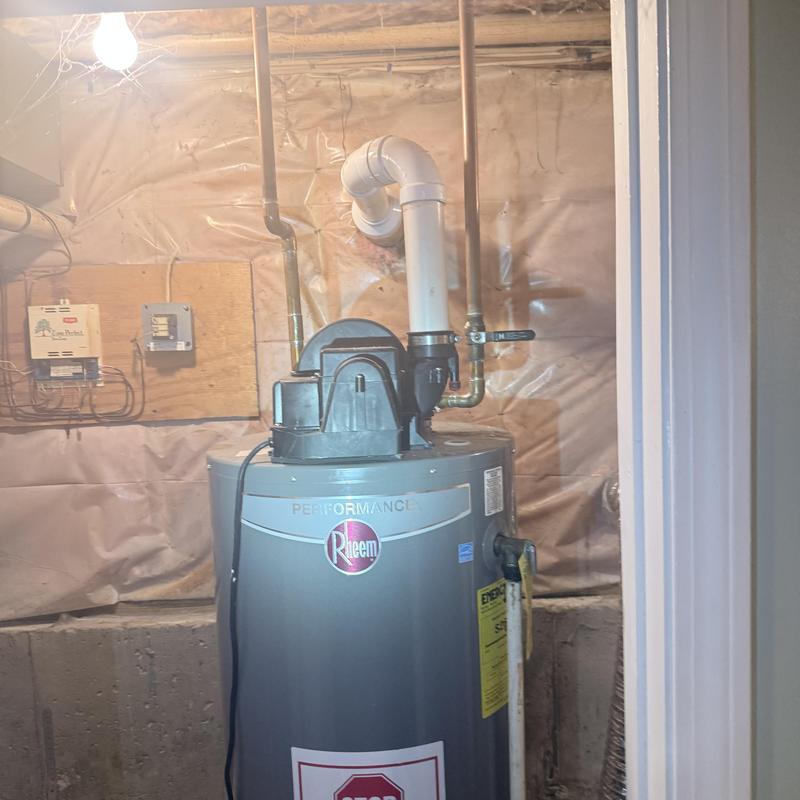 Electric water heater installation in basement utility room