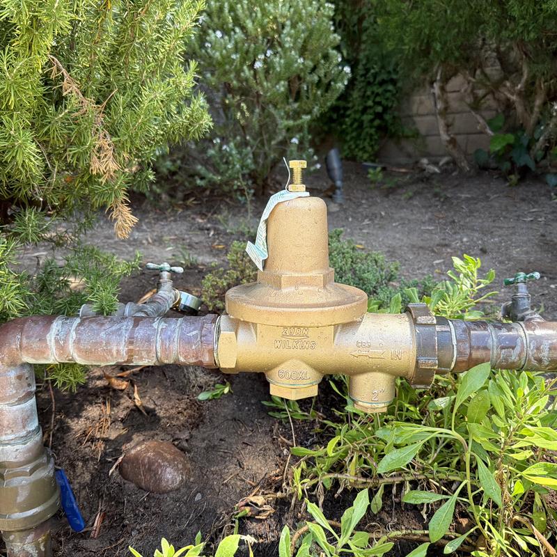 Pressure regulator valve installed on irrigation pipe outdoors Pressure regulator valve installed on irrigation pipe outdoors
