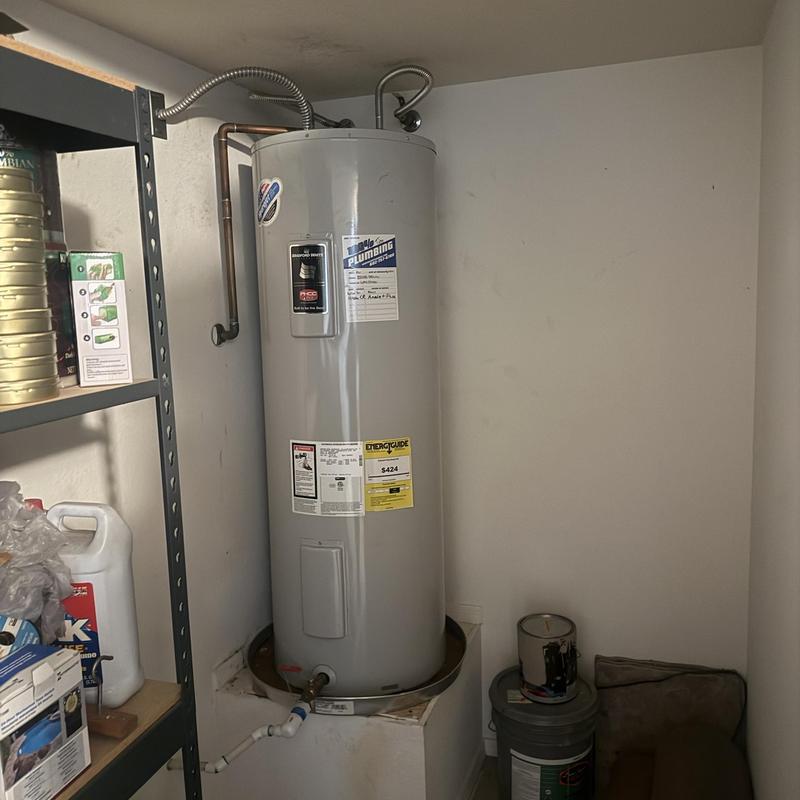 Electric water heater installed in utility room