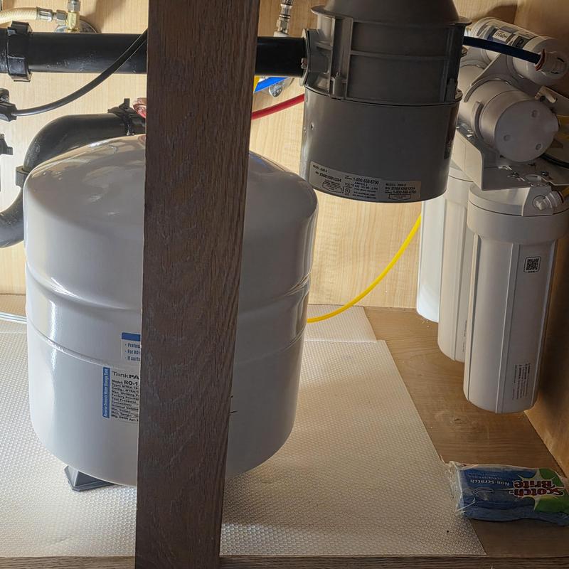 Reverse osmosis drinking water system installation in cabinet Reverse osmosis drinking water system installation in cabinet