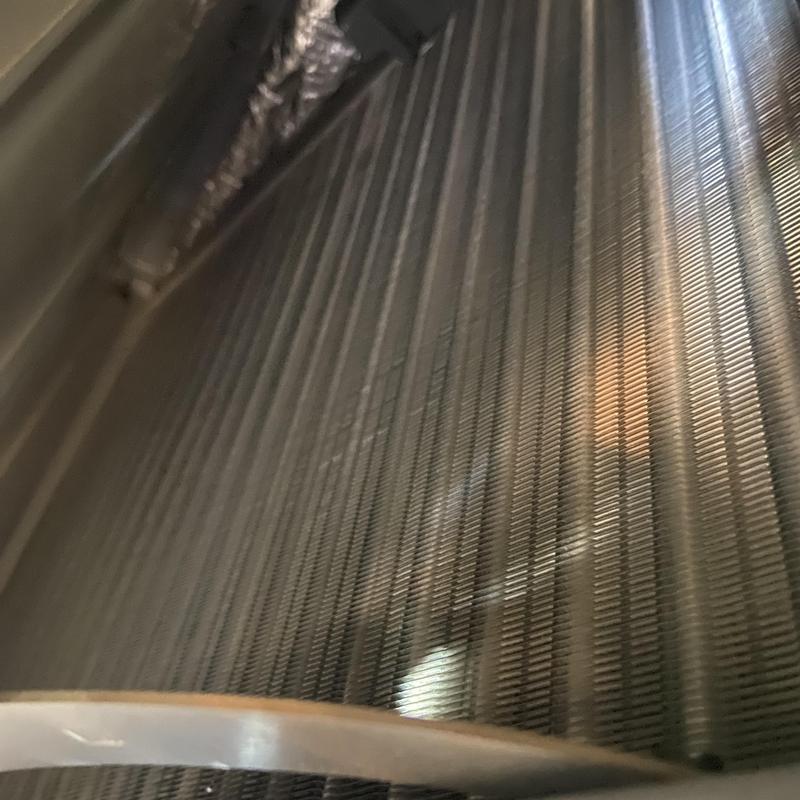 HVAC evaporator coil close-up with refrigerant leak repair HVAC evaporator coil close-up with refrigerant leak repair