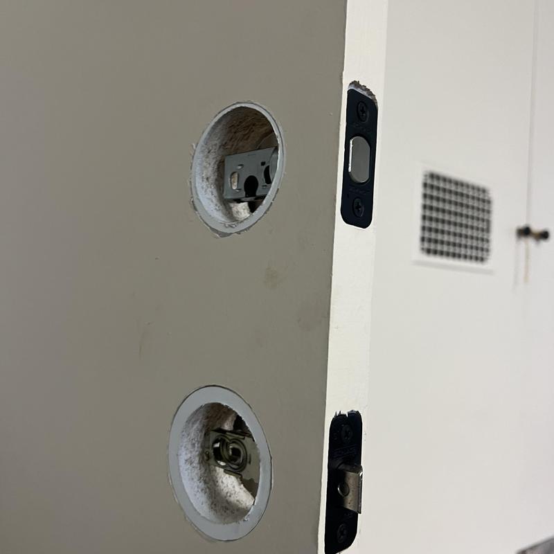 Door knob and deadbolt holes drilled for lock installation
