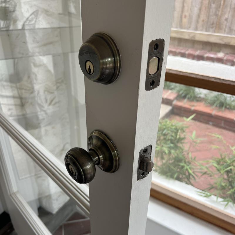 Door knob and deadbolt lock on white door