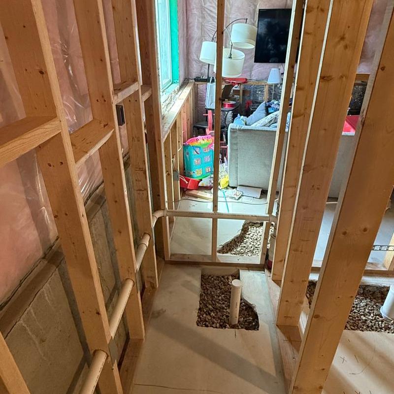 Basement plumbing rough-in with drain pipes installed