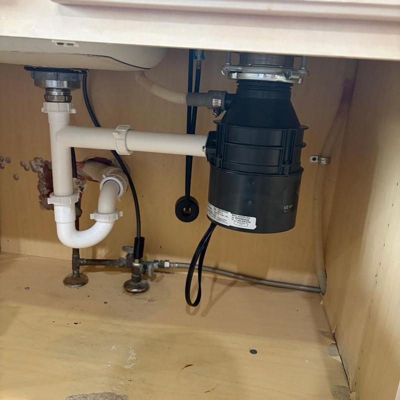 Garbage disposal unit and sink plumbing installation