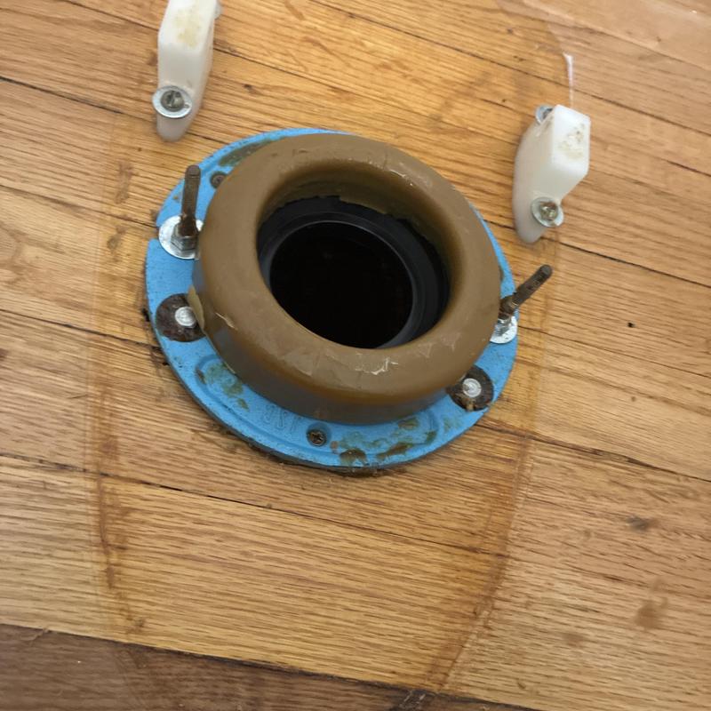 Toilet flange with wax ring on hardwood floor