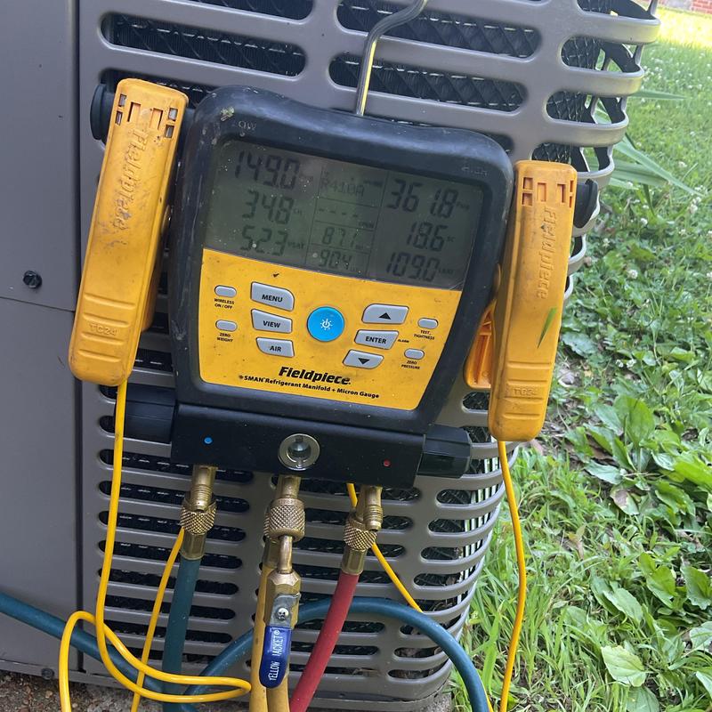 Refrigerant manifold gauge on AC unit evaporator coil Refrigerant manifold gauge on AC unit evaporator coil