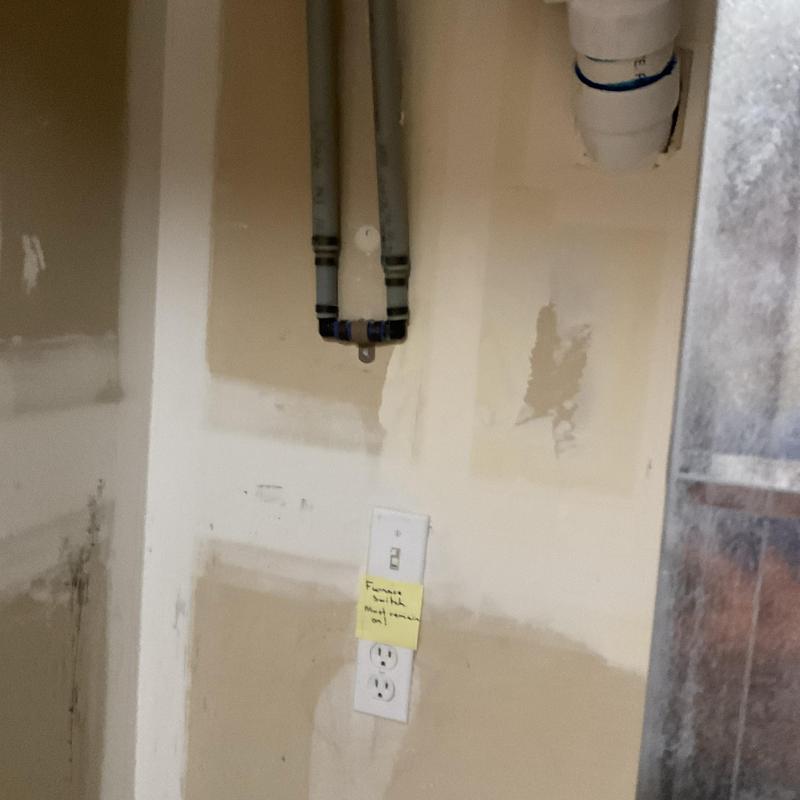 Water softener pipes and electrical outlet in utility room Water softener pipes and electrical outlet in utility room