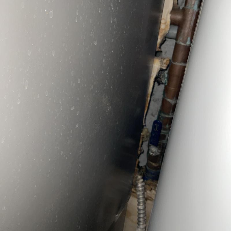 Water heater side view with piping and valve Water heater side view with piping and valve