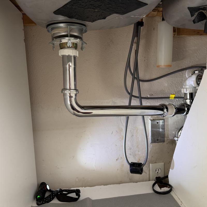 Bathroom sink metal drain pipe installation under sink