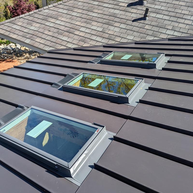 Metal roof with three skylights installed Metal roof with three skylights installed