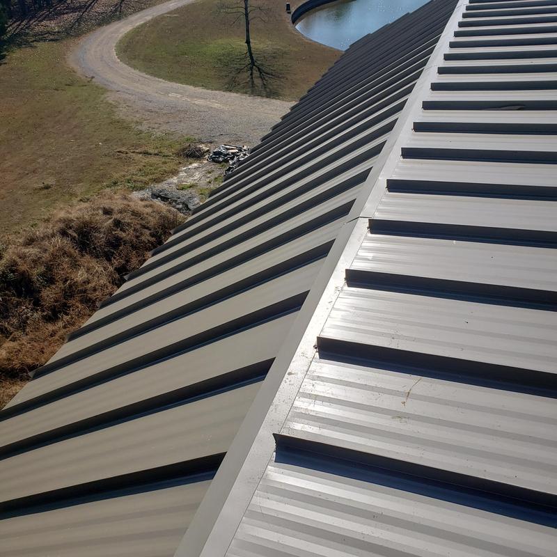Standing seam metal roofing panels on residential roof Standing seam metal roofing panels on residential roof