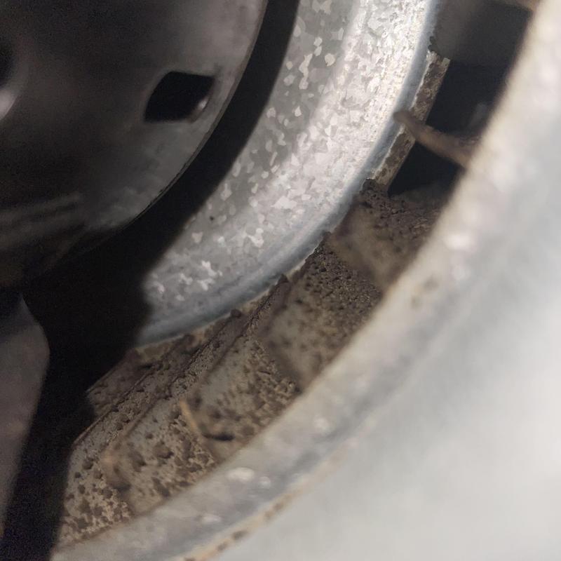 Blower wheel with dirt buildup inside HVAC unit