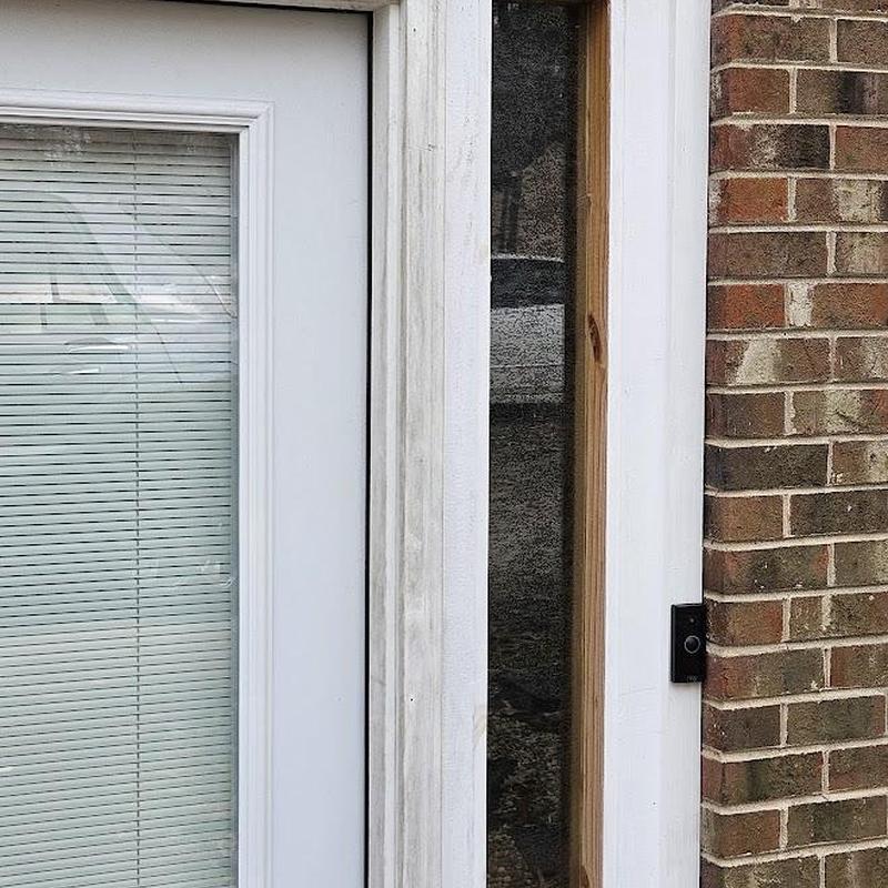 Window frame installation next to brick wall and doorbell Window frame installation next to brick wall and doorbell